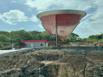 Gas station with modern canopy structure adjacent to commercial land opportunity on Panamericana Highway