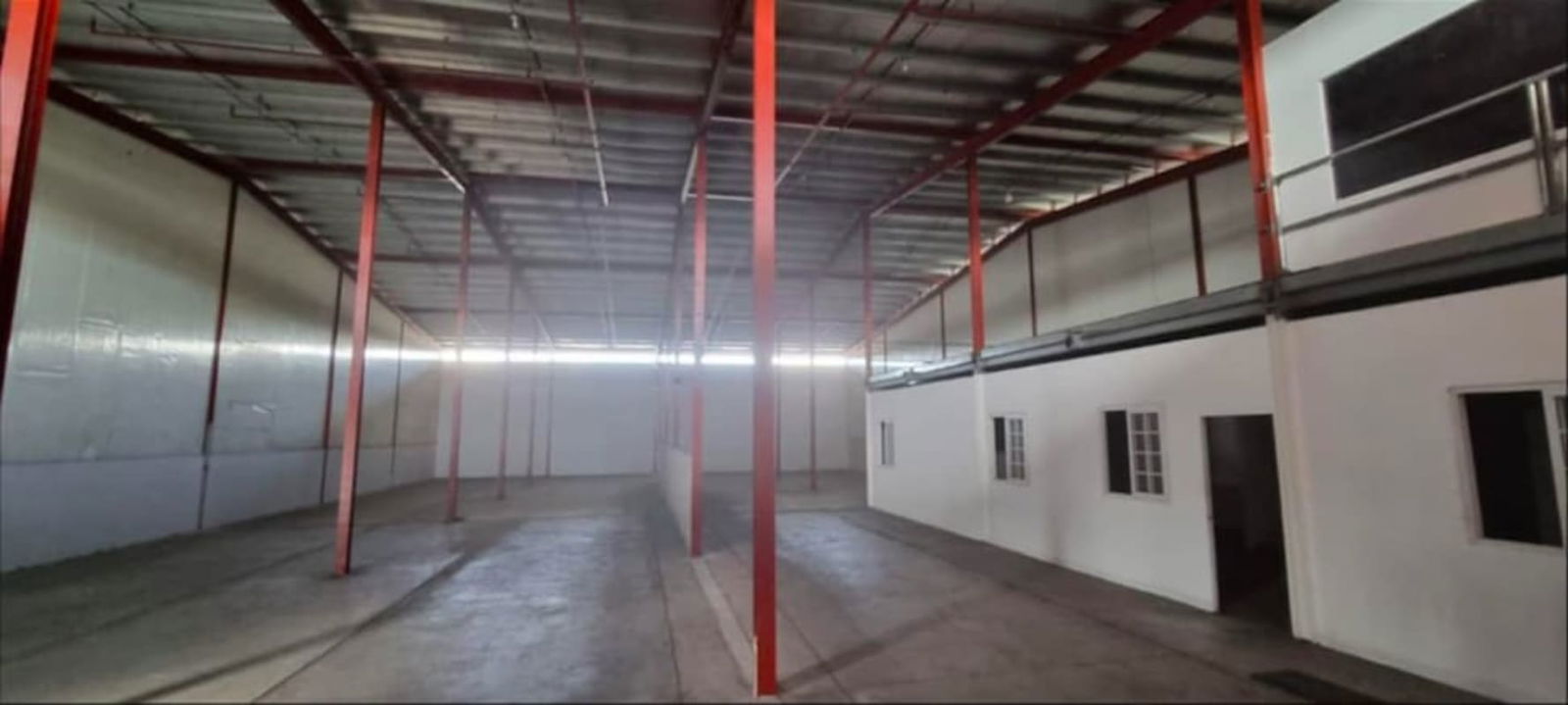 Large empty warehouse space with ceiling beams inside PH Tocumen Logistic Center Panama City