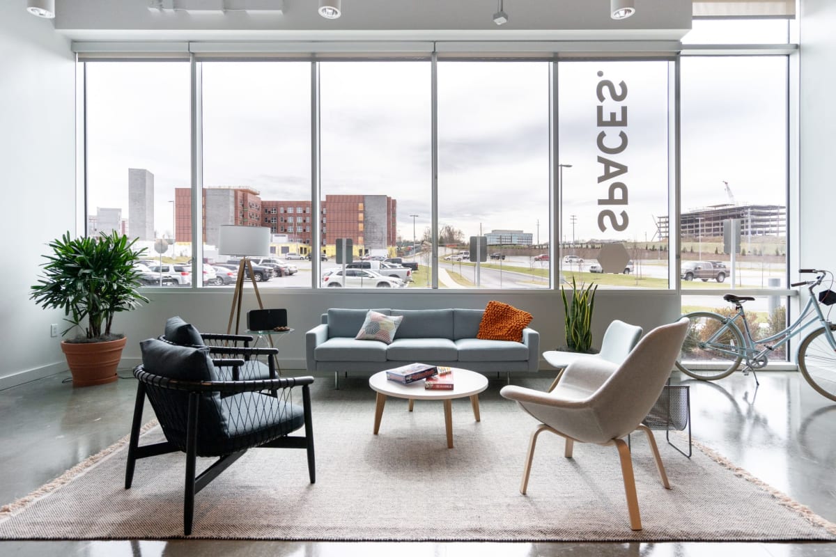 Large coworking common area with windows, armchairs and plants at Spaces Plaza 2000 Panama