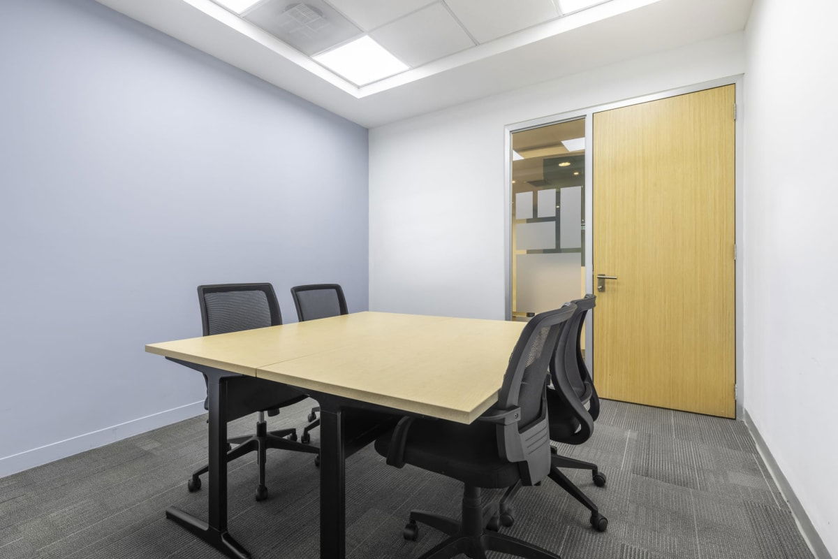 Small meeting room with conference table and mesh chairs in Tower Financial Center Panama City