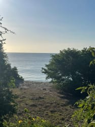 Balancing rocks on sandy beach with ocean waves and sunset at Costa Esmeralda San Carlos Panama.