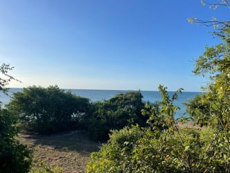 Sunset view over black sand beach and oceanfront estate land in Costa Esmeralda West Panama.