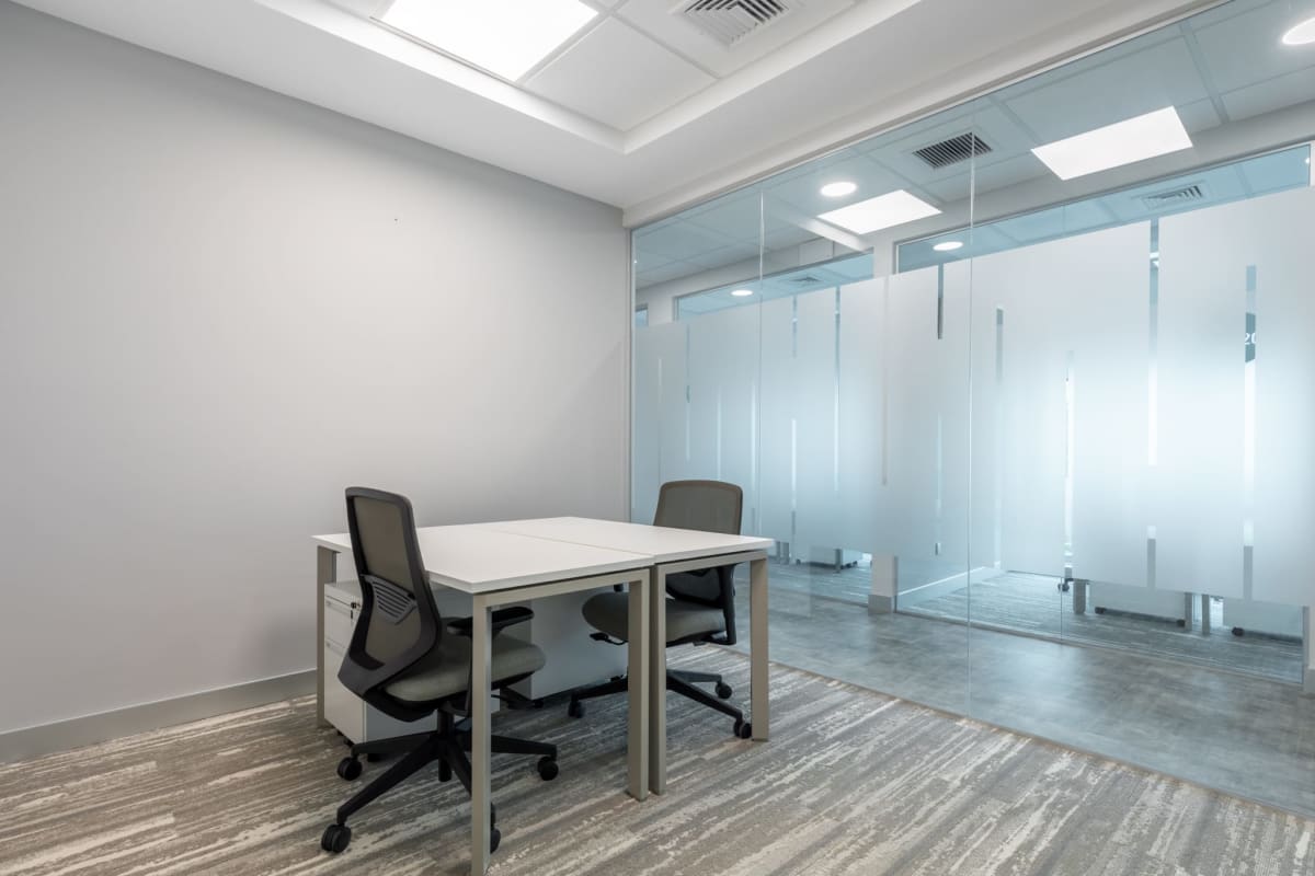 Private workspace with large window desk chair and built-in shelving Banistmo Tower Panama City