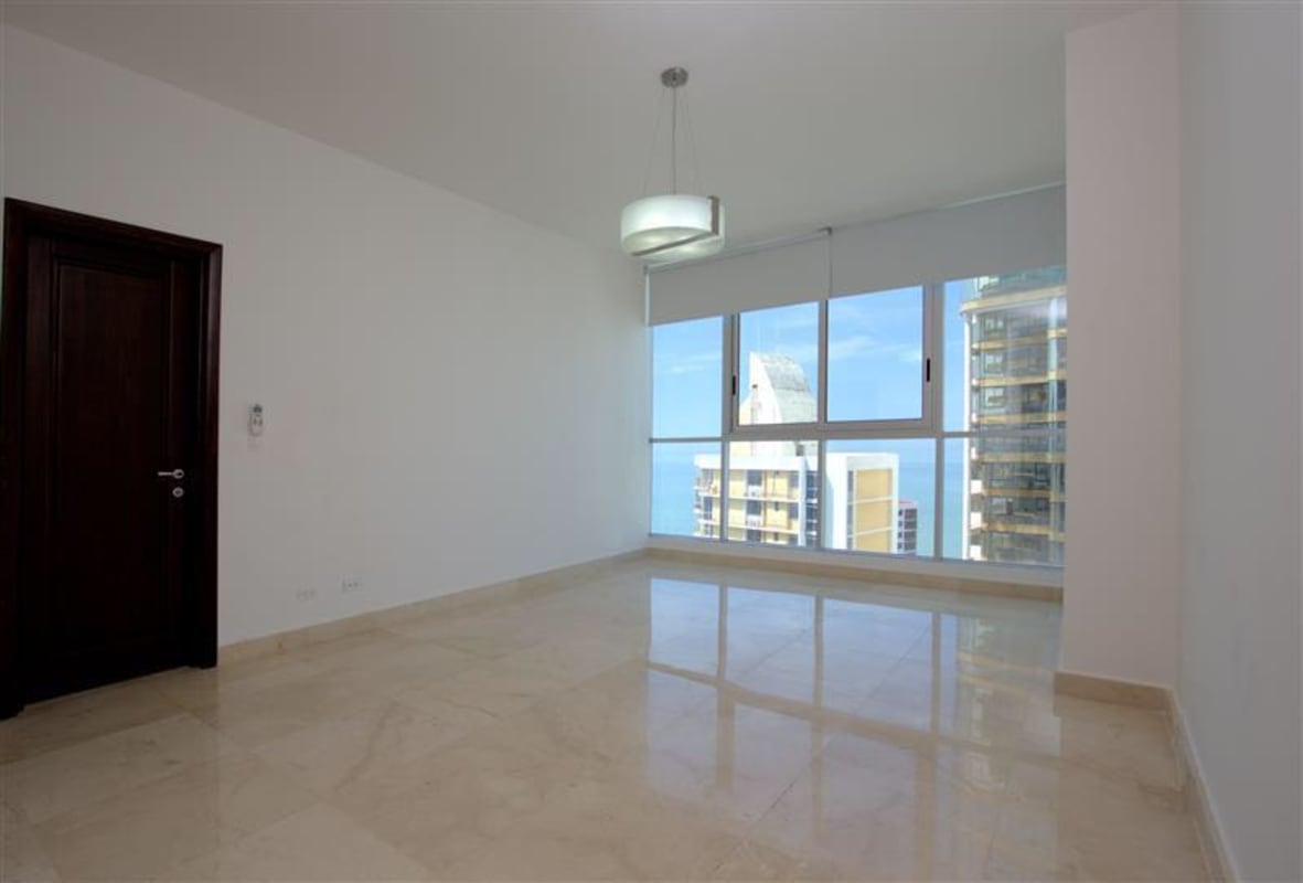 Bright living room with marble floors, floor-to-ceiling windows and skyline views in PH Aventura Panama