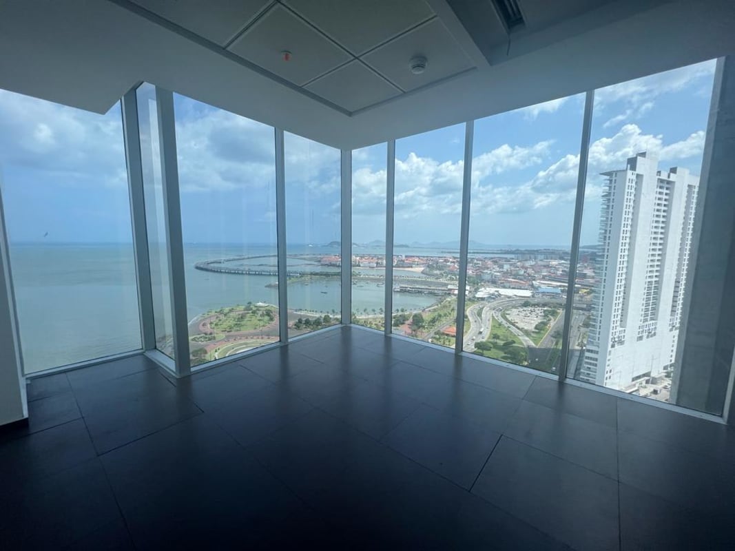 Large empty modern office with floor-to-ceiling ocean view windows inside PH BOC Avenida Balboa Panama