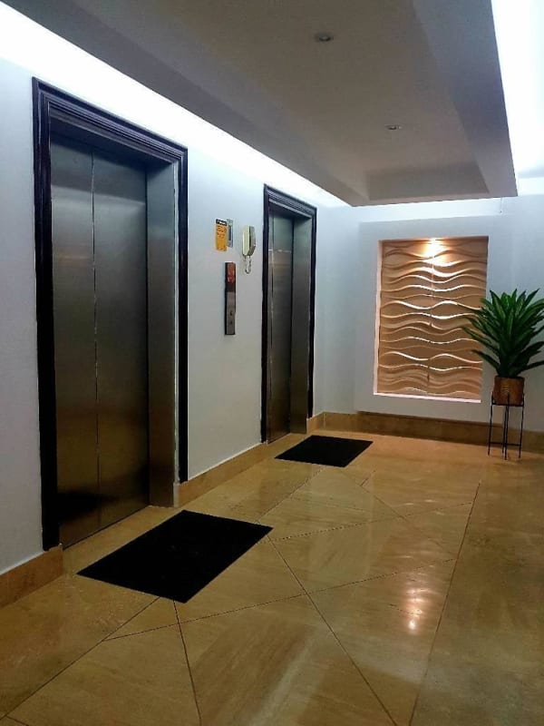 Modern elevator lobby with marble floors, stainless steel elevators, and designer finishes in PH Emporium Tower