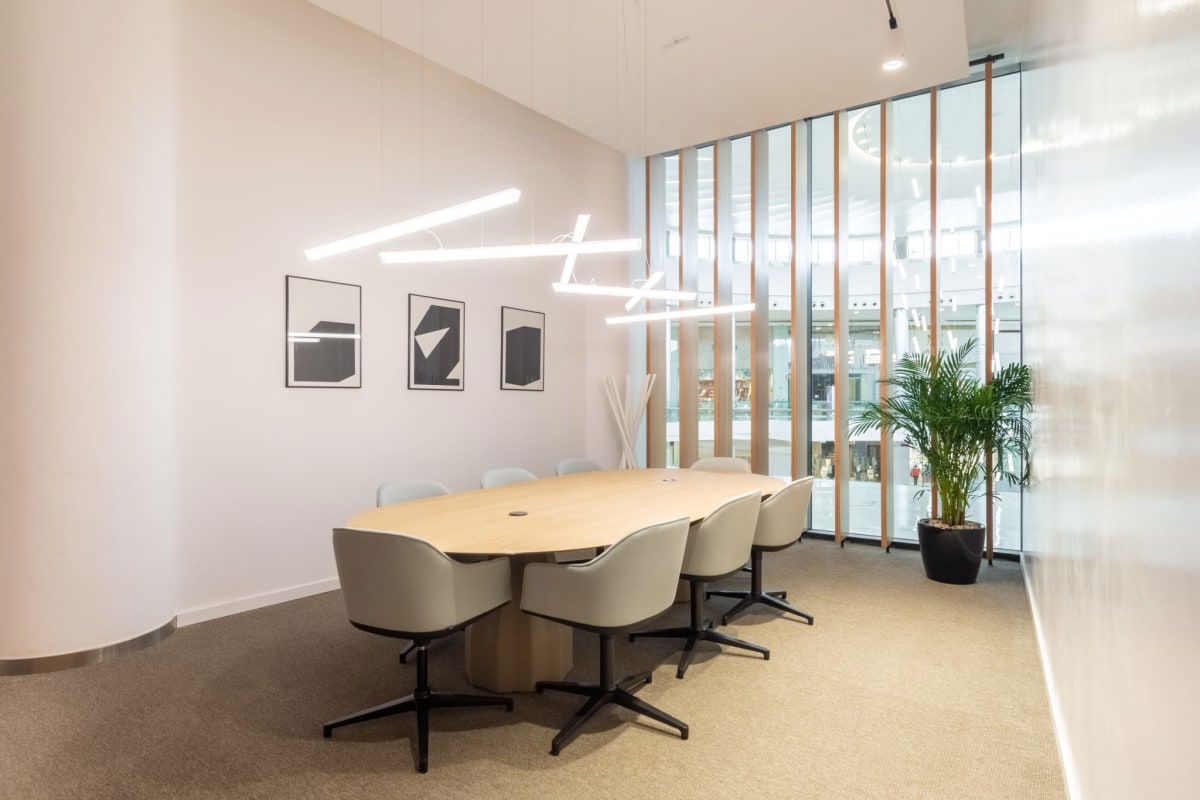 Conference room with wood table, gray chairs, glass wall at Plaza 2000 Panama