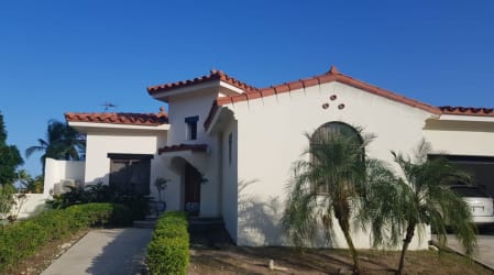 Elegant Mediterranean style villa with arched windows, tiled roof at VistaMar Resort San Carlos Panama