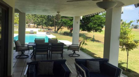 Covered terrace with dining overlooking private pool in golf beachfront villa VistaMar San Carlos Panama