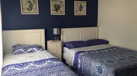 Double bedroom with twin beds, coastal decor and bright ambience at VistaMar Villa in Panama