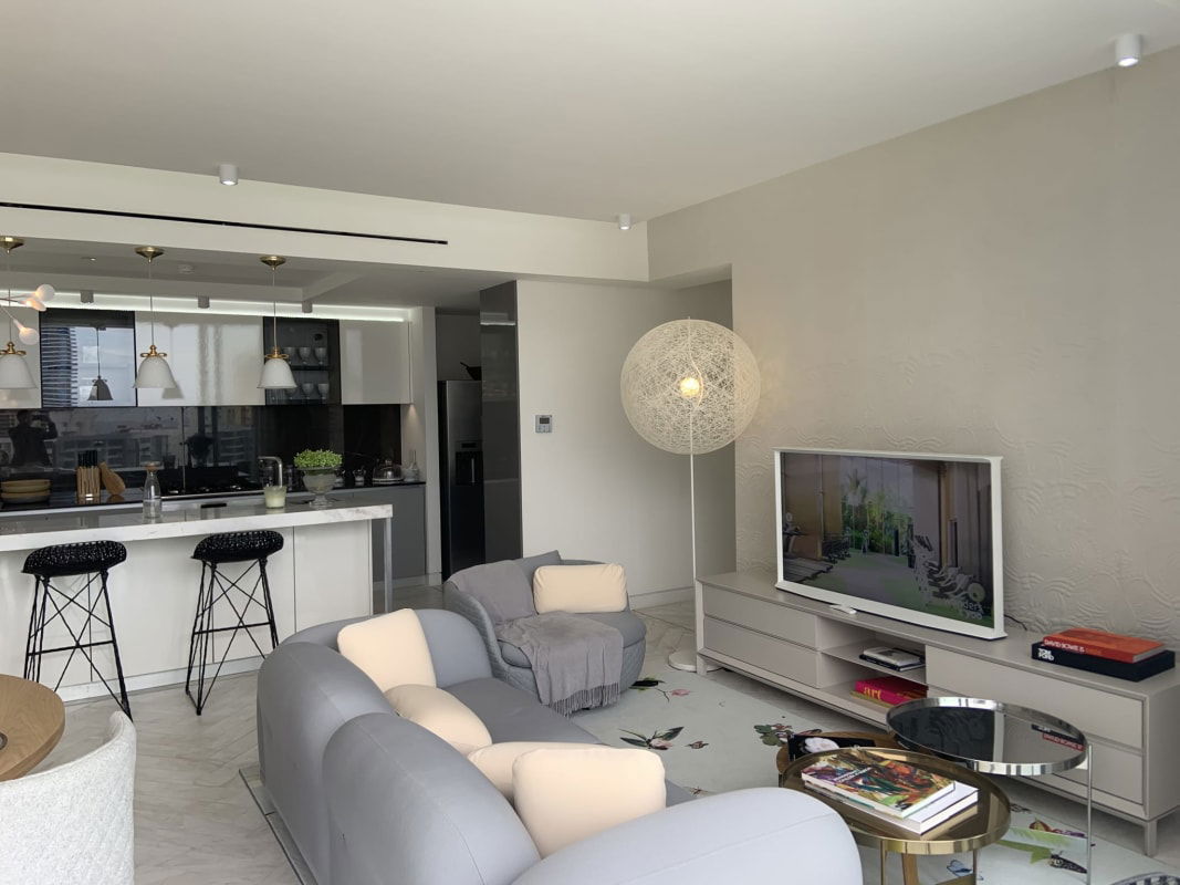 Luxury bathroom in Ocean Reef condo with double sink vanity and glass shower, marble walls