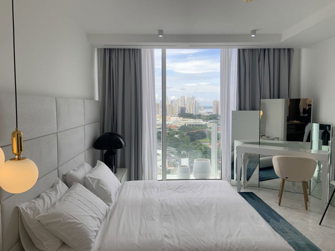 Spa-style master bathroom with marble wall walk-in rain shower at Punta Pacifica