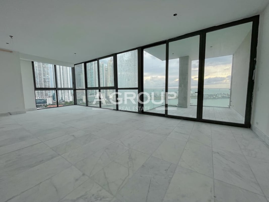 Spacious living room with marble floors and floor-to-ceiling windows at PH Sea Point Punta Paitilla Panama