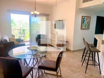 Living and dining area with balcony access featuring forest views in PH Forest Tower Panama Pacifico