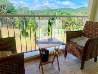 Balcony with mountain forest Panama Canal view wicker chairs PH Forest Tower Panama Pacifico