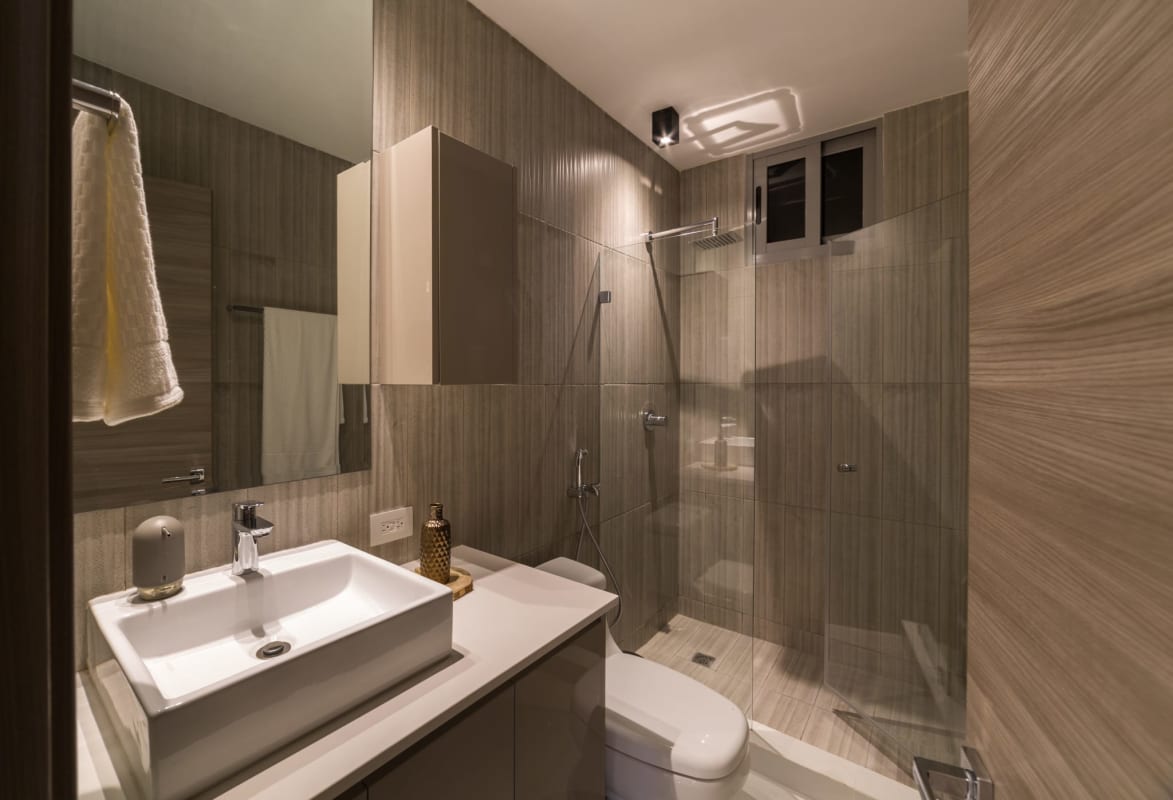 Modern bathroom with granite counter, vessel sink, glass shower PH Cangrejo Suites El Cangrejo