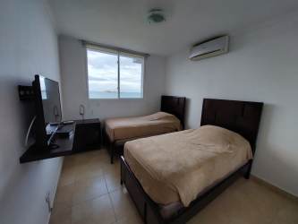 Twin beds bedroom with large ocean view windows Playa Blanca Resort