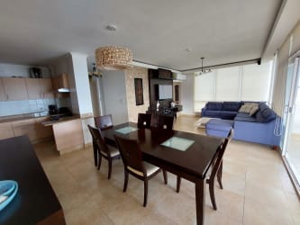 Spacious living dining area with large windows in Playa Blanca Resort condo