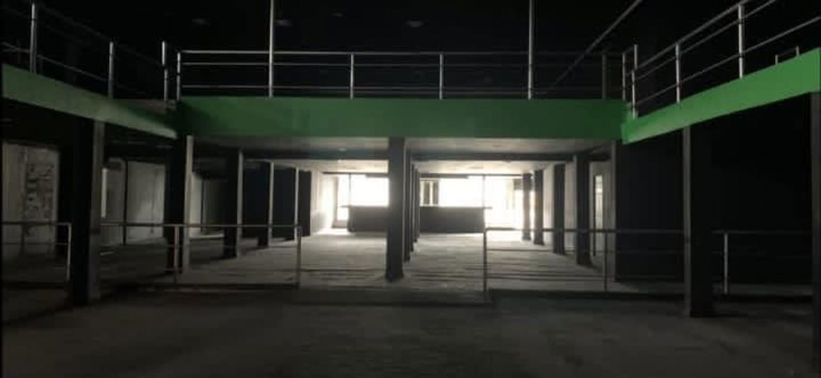 Two-story commercial building exterior with large parking lot on Via Transistmica Los Ángeles Panama