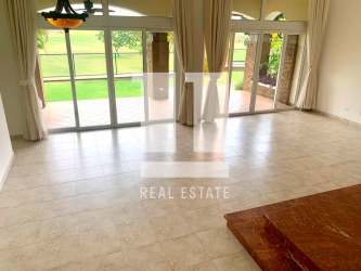 Open living room with large windows, golf view, marble floors in luxury villa Panama