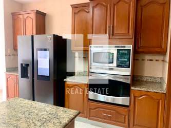 Wood cabinetry kitchen with granite countertops, stainless appliances in luxury villa Panama City
