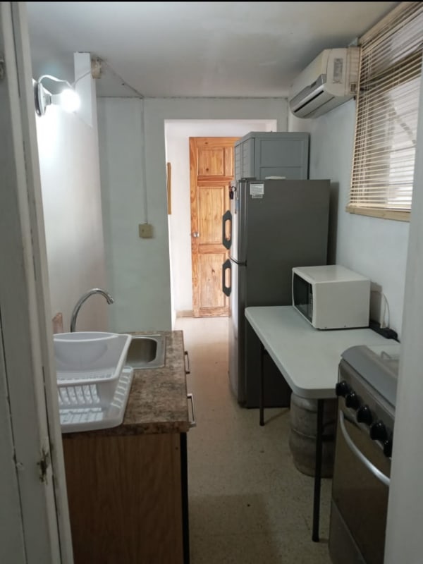 Kitchen with sink, fridge, microwave, stove studio apartment Villa de las Fuentes Panama