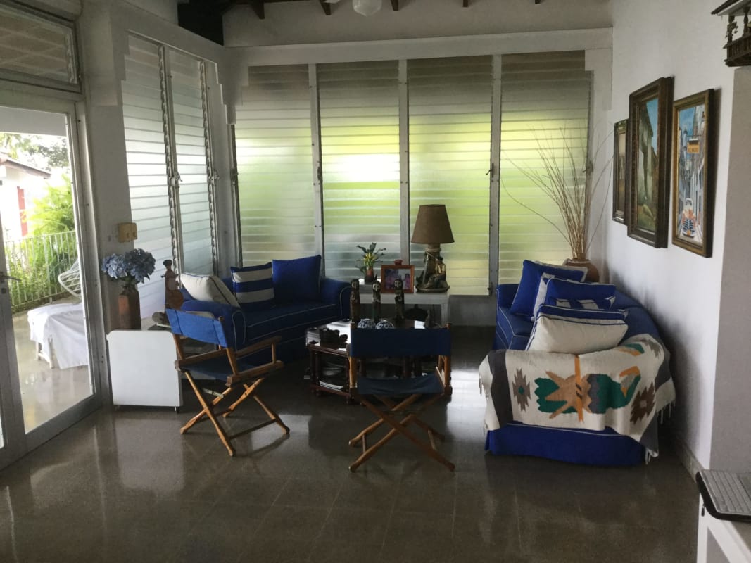Charming retro kitchen with white cabinetry, red tile backsplash, and modern appliances in Coronado beach villa