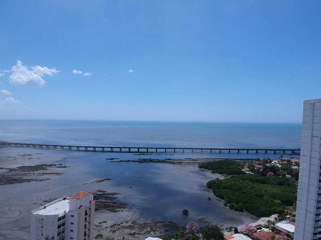 Vacant lot outlined near high-rise towers and coast in Altos del Golf Panama