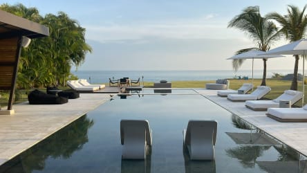 Swimming pool with lounge chairs hammock ocean view beachfront villa Casamar Panama