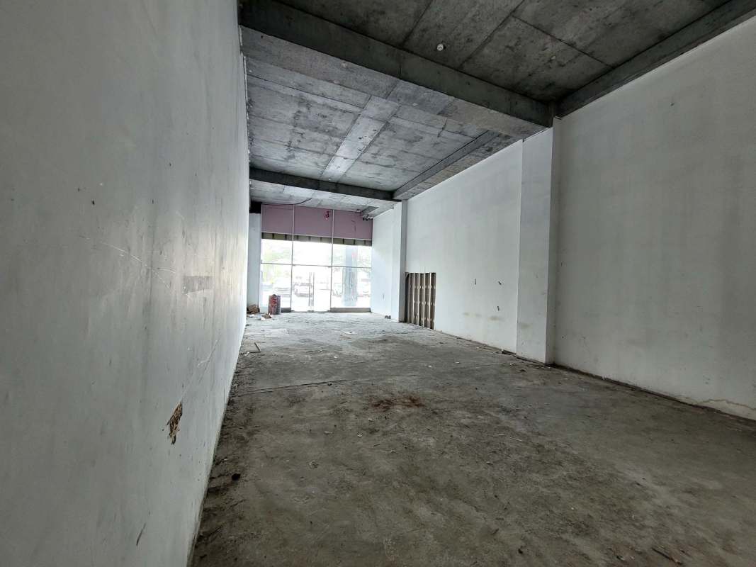 Vacant commercial retail space double height ceiling concrete floor Dorado City Center