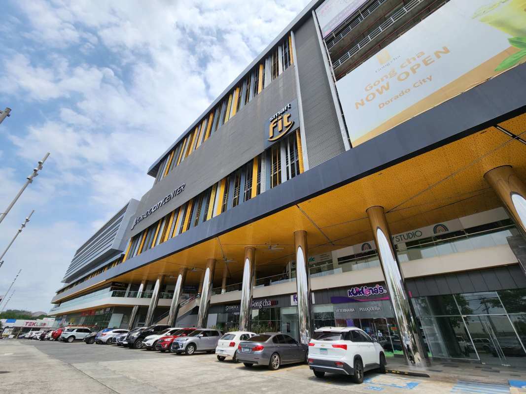 Multi-story commercial retail building with shops and parking Dorado City Center