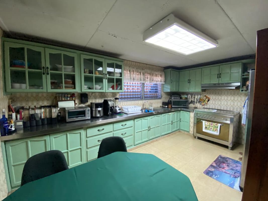 Traditional bathroom with glass enclosed shower and vessel sink in Bethania Panama house