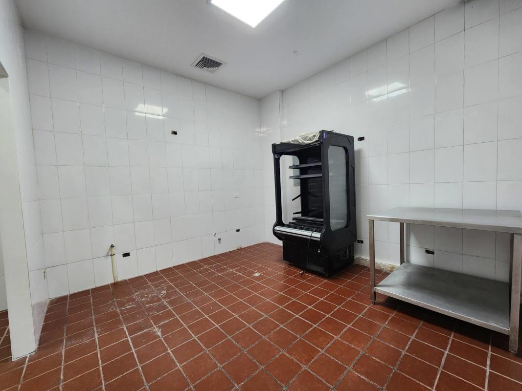 Utility kitchen with white tiles and prep counter in Mercato Food Court Torre Banesco Panama City