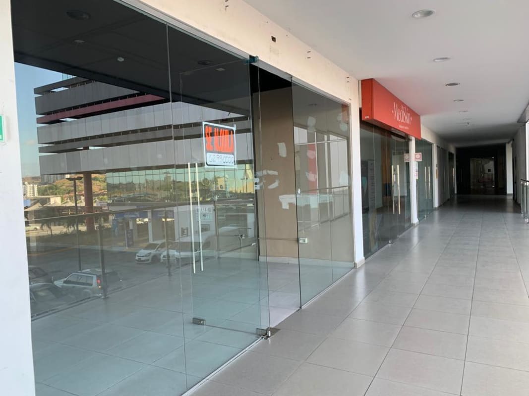 Indoor commercial corridor with glass shopfronts PH Centennial Center Condado del Rey Panama City