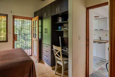 Cozy rustic living room with exposed beams, tile floors, countryside decor in mountain house Panama