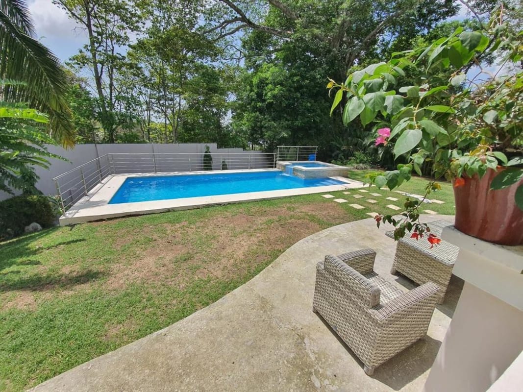 Spacious living room with large windows, double height ceiling, and chandelier Betania Panama