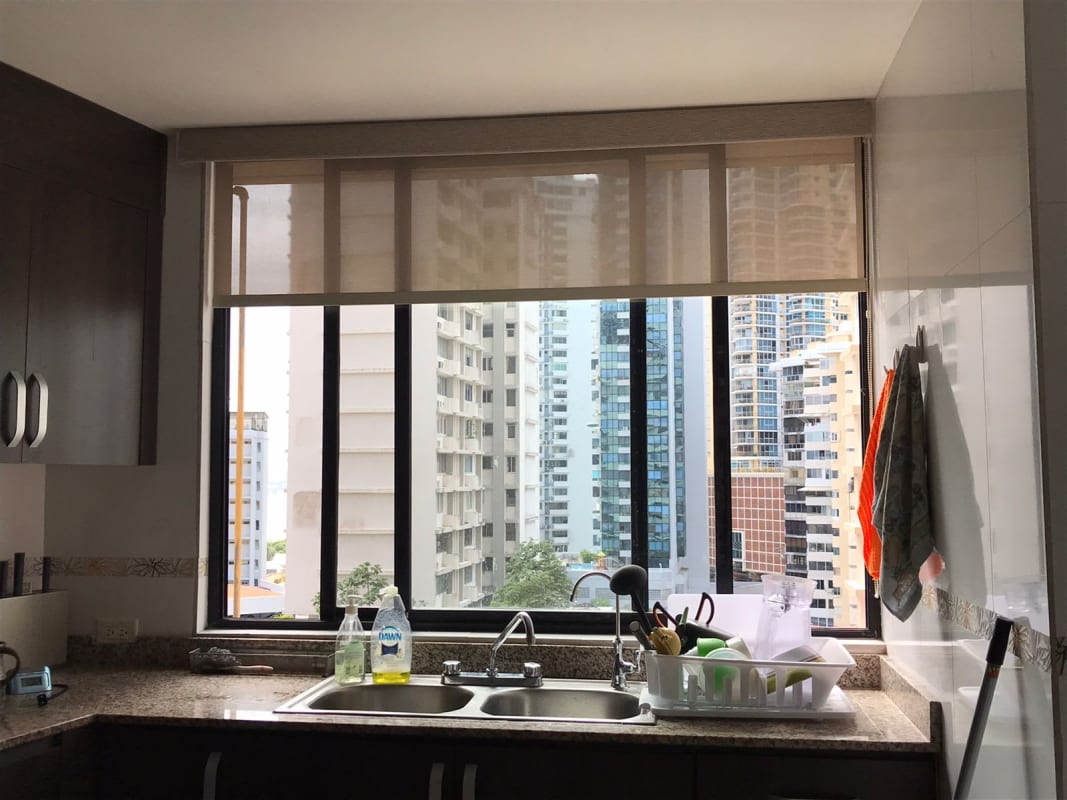 Spacious kitchen with granite counters, double sink, city view window in PH Royal Princess Panama