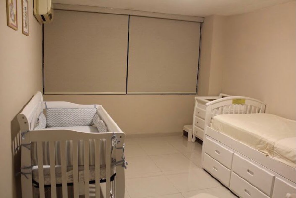 Modern nursery with crib, twin bed, changing station and blinds PH Royal Princess Paitilla