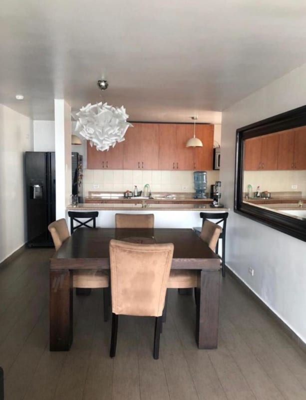 Open plan kitchen with dining table and mirror contemporary furnished rental in San Francisco Panama