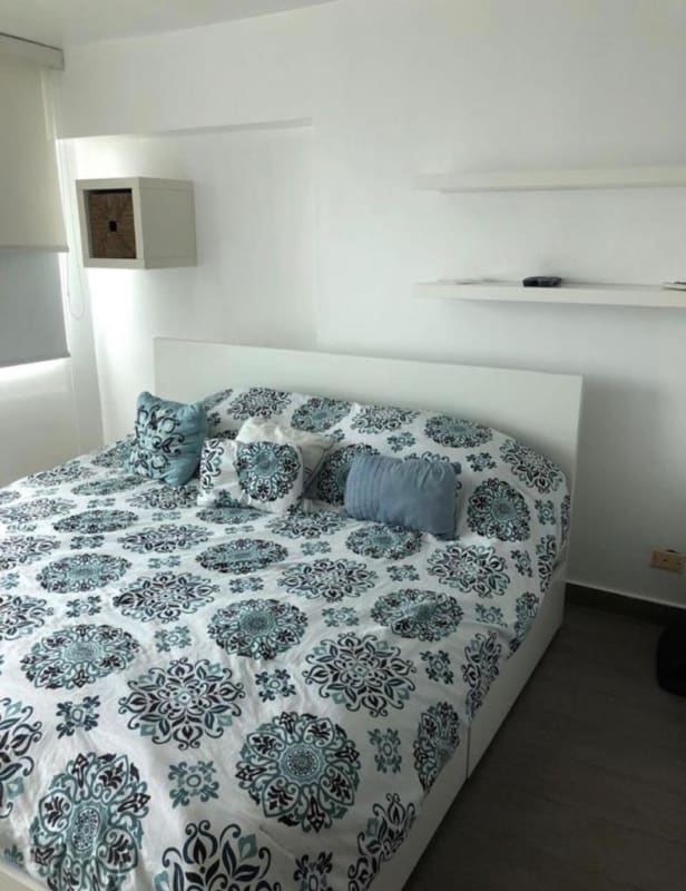Bright furnished bedroom with queen bed and floating shelves PH San Francisco Panama apartment