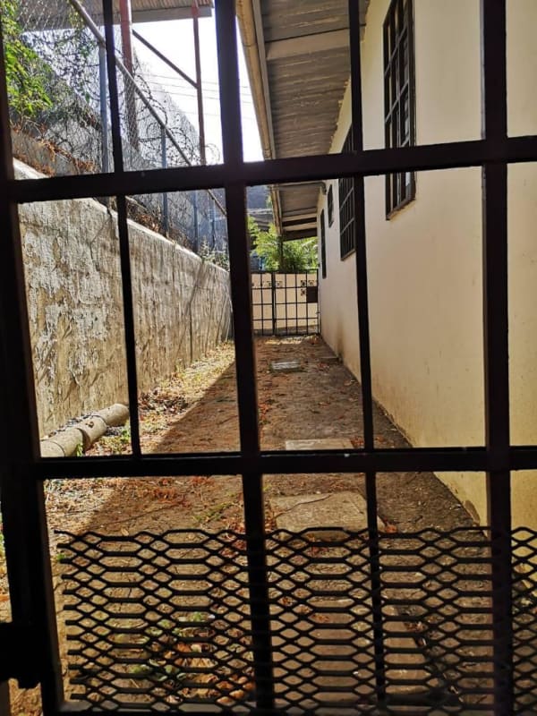 Narrow exterior walkway with fencing and gate Cerro Lindo Condado del Rey Panama