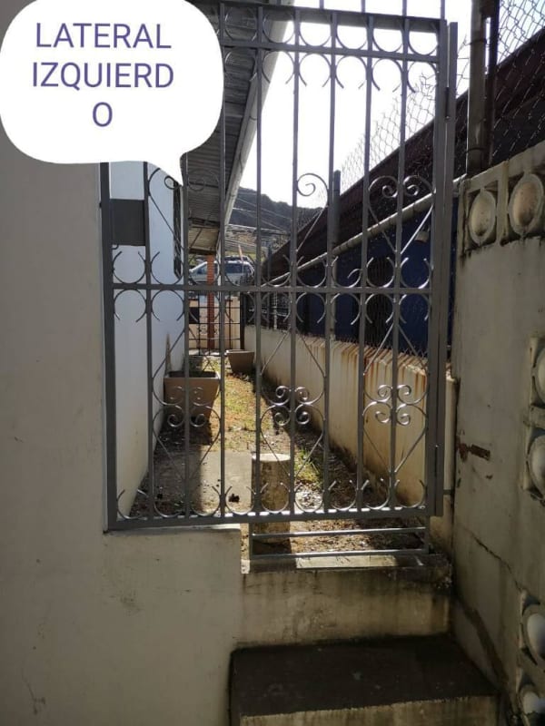 Side yard with metal decorative gate and fenced enclosure, Cerro Lindo Panama
