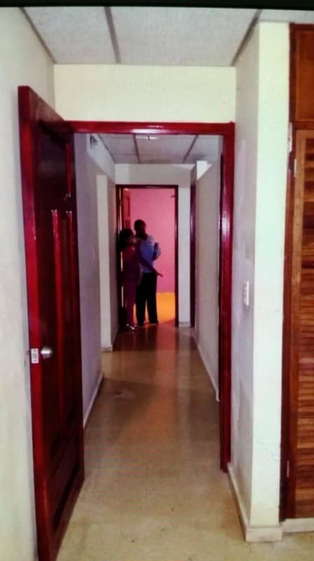 Hallway with tile ceiling, neutral walls, red door frames Cerro Lindo House Panama City