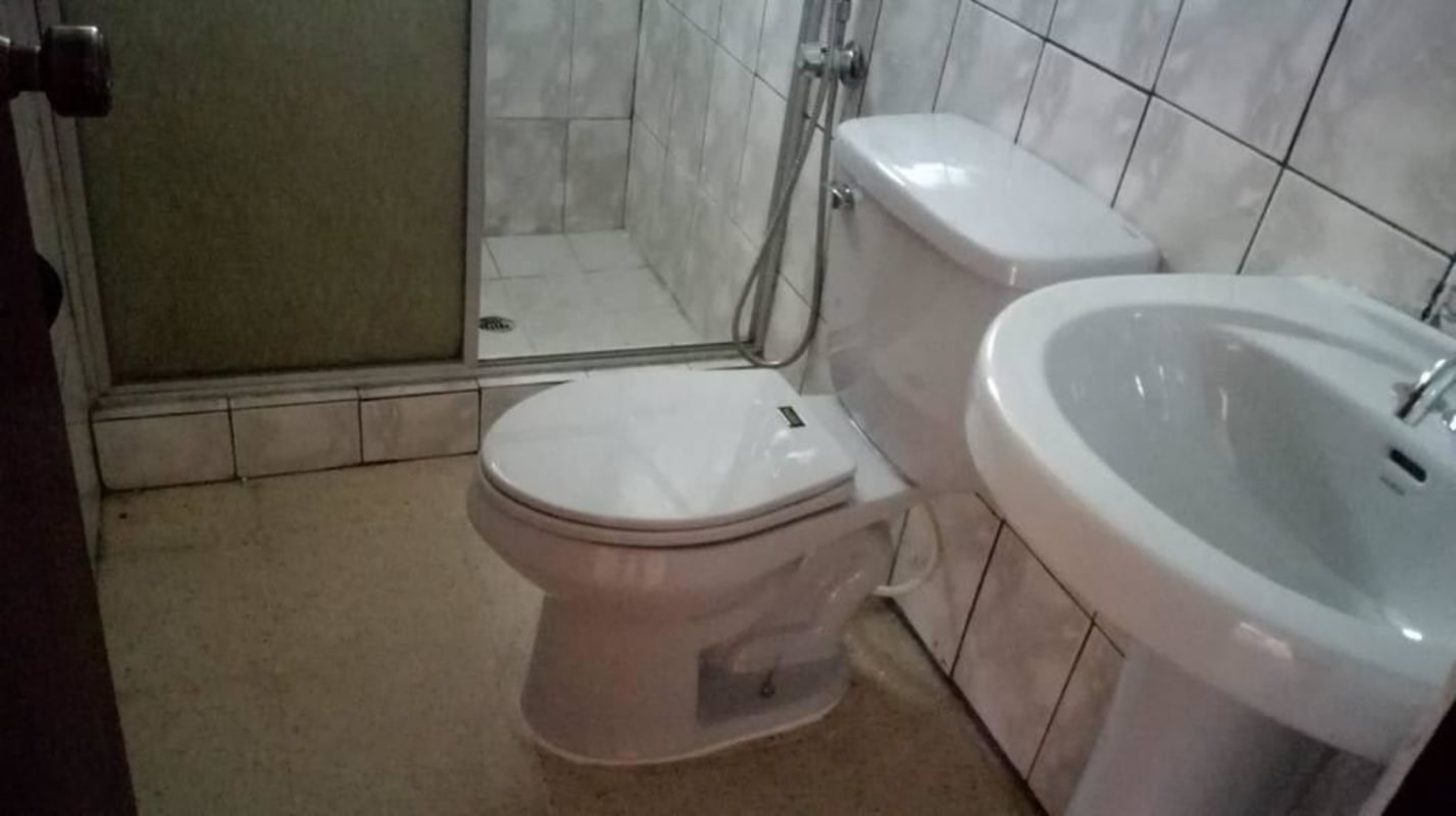 Small bathroom with pedestal sink and shower glass enclosure Cerro Lindo Condado del Rey Panama