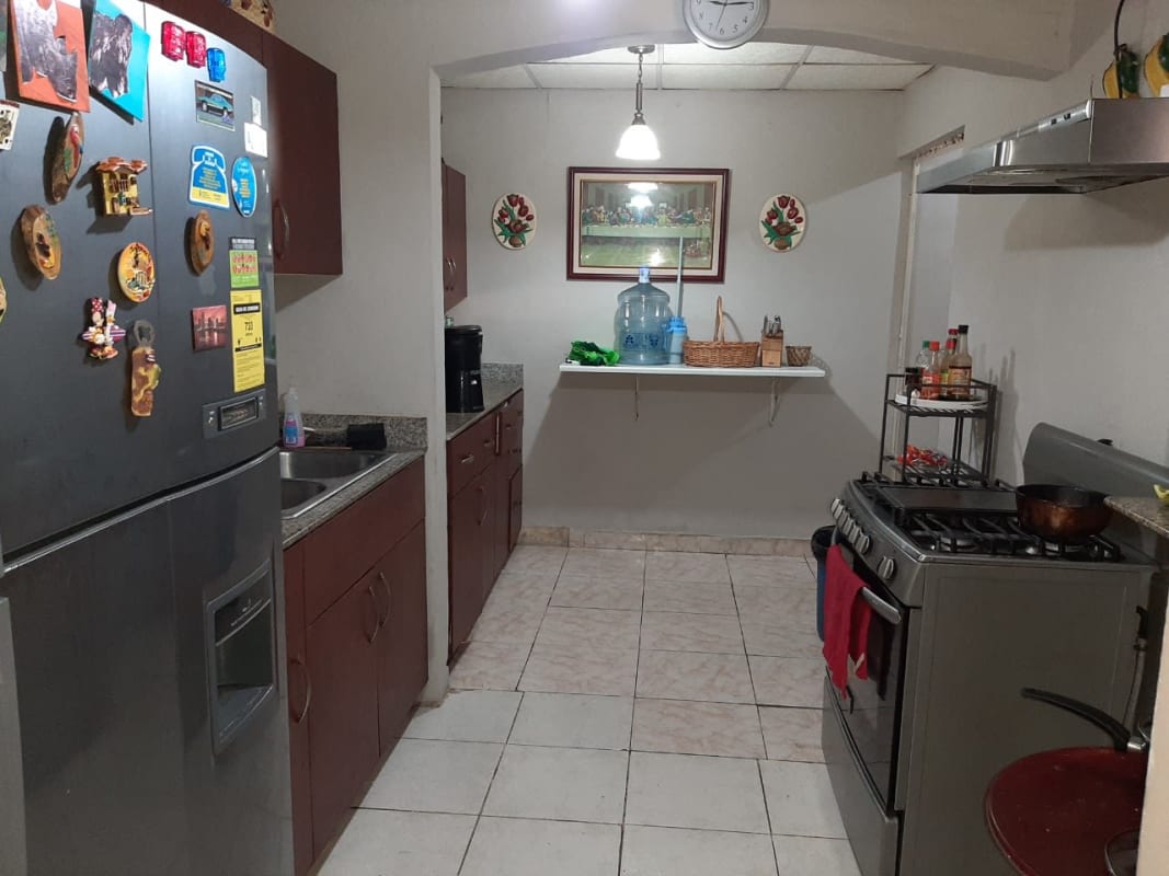 Kitchen with granite countertops, refrigerator, gas stove, tile backsplash Praderas del Rocio Panama City