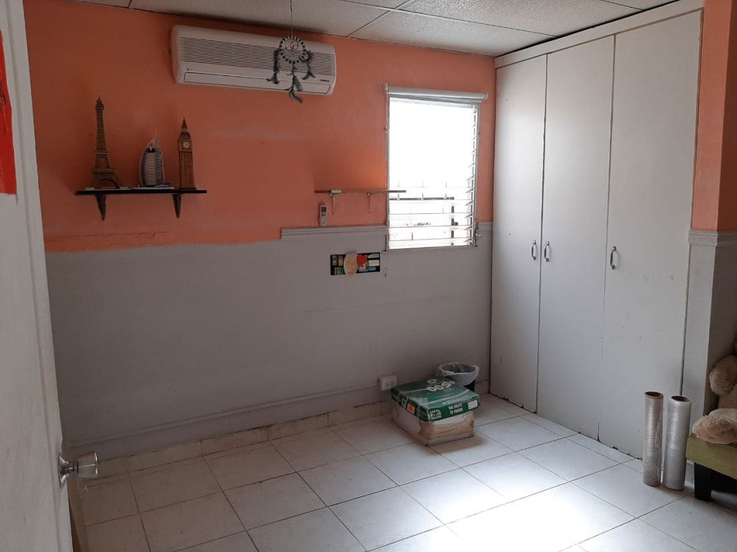 Private balcony with outdoor seating, exercise bike, tiled floor overlooking neighborhood in Panama City