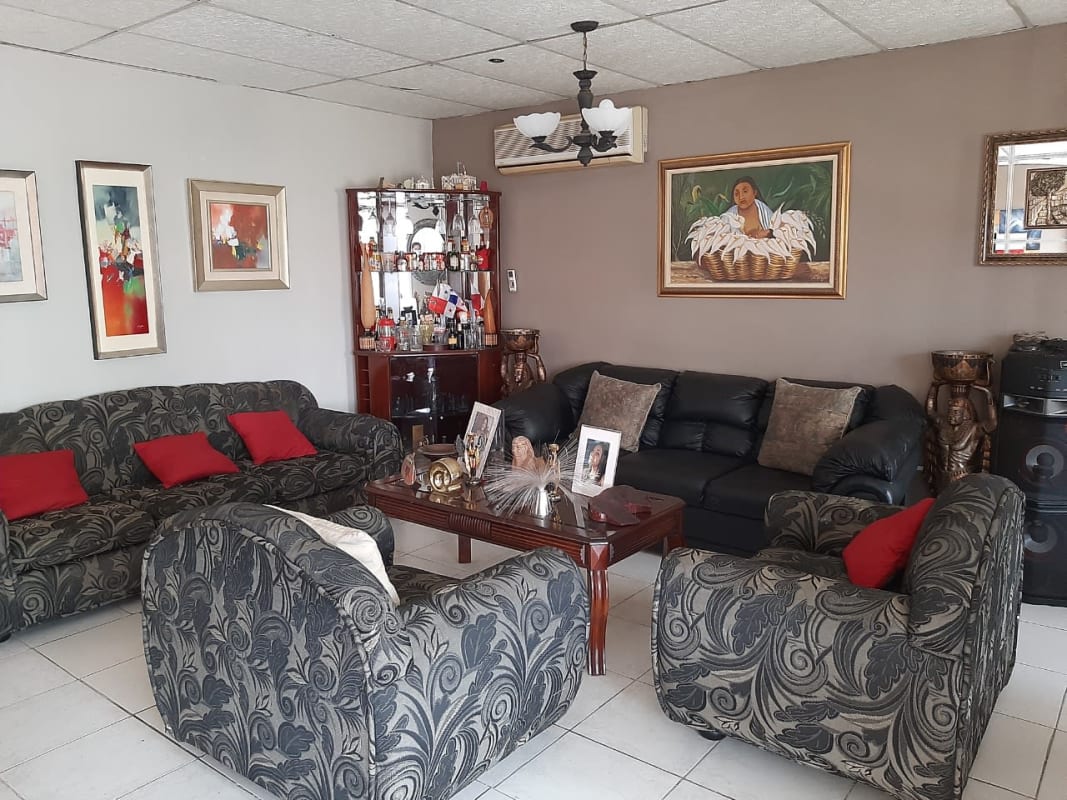 Spacious living room with armchairs, sofa, artwork, tile floors in Praderas del Rocio Panama