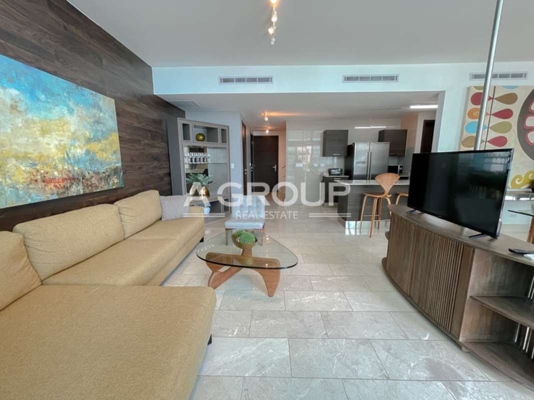 Open gourmet kitchen with granite countertops and stainless appliances in luxury loft at PH Grand Tower Punta Pacifica