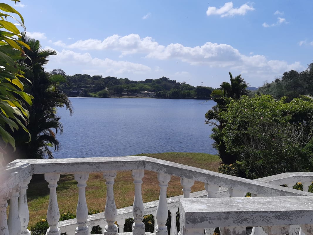 Covered porch with classical columns and garden views in lakeside Panama house Las Cumbres