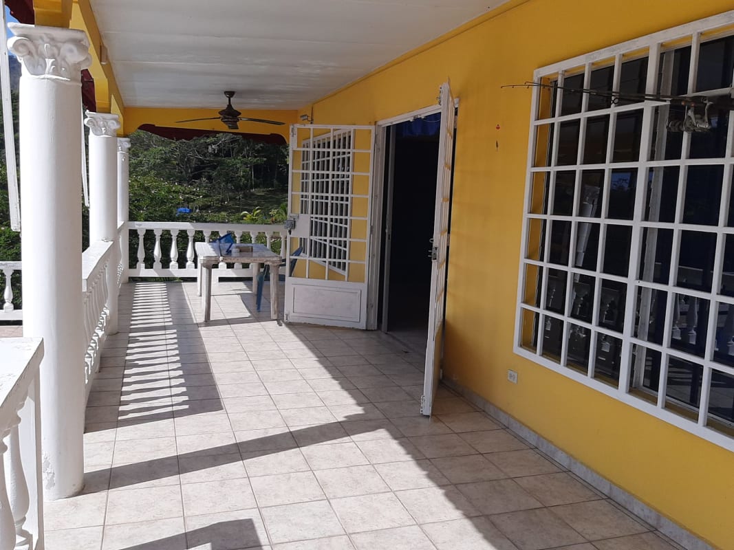 Tiered backyard with balustrade fence pool and lake scenery in Las Cumbres Panama